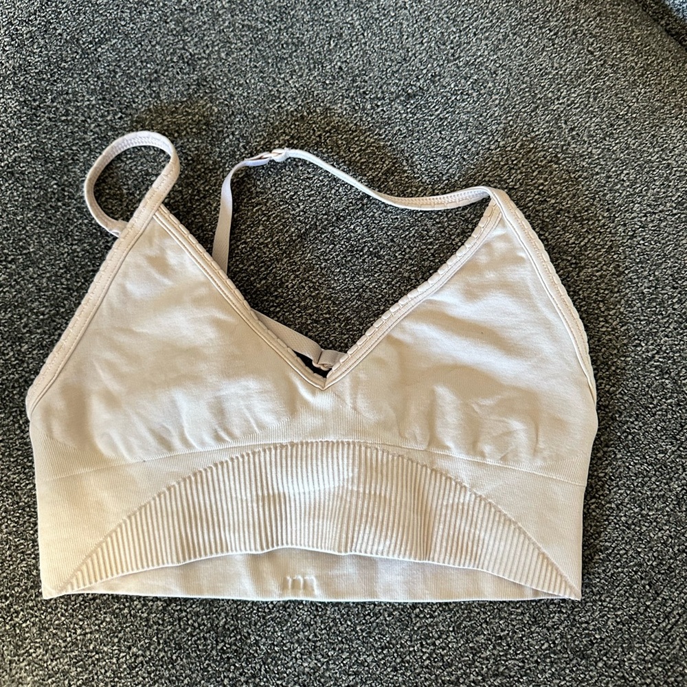 Lululemon size 4 women’s bra. First as a size 2. Or size small.Light pink color.